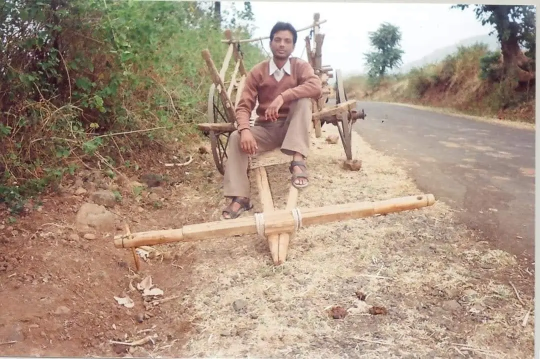 The author, Shirish Khare, on the road through Virat village, sitting on a bullock cart by the roadside